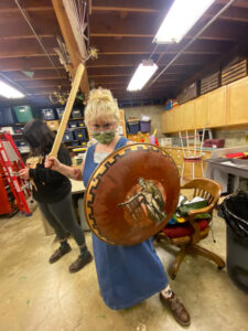 Izzy Pedego (Agnes Evans) With Rehearsal Sword And Shield In The Prop Shop.